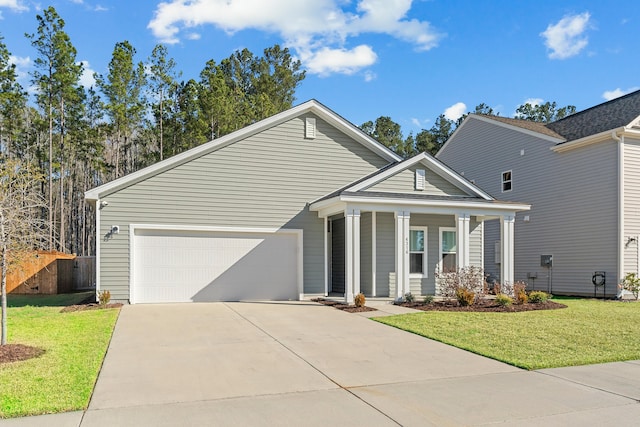 view of front of house with a front yard, a garage, and driveway