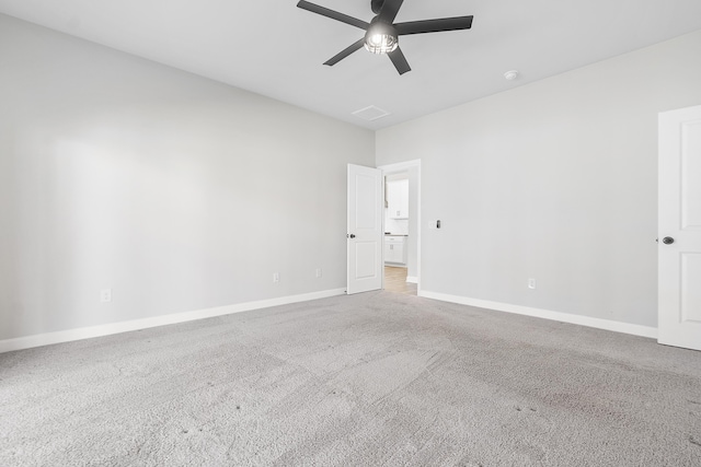 carpeted spare room with baseboards and a ceiling fan