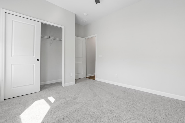 unfurnished bedroom with a closet, baseboards, and carpet floors