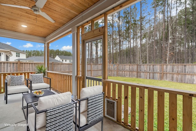 sunroom / solarium with wooden ceiling and a ceiling fan