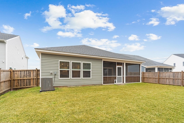 back of property featuring a fenced backyard, central AC, a yard, and a sunroom