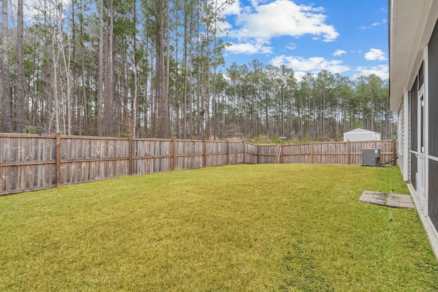 view of yard featuring central AC unit and a fenced backyard