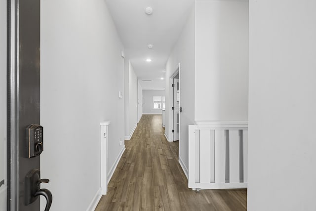 hallway with baseboards and wood finished floors