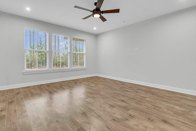 spare room featuring ceiling fan and light hardwood / wood-style floors