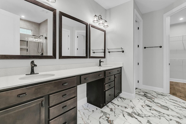 bathroom with a shower and vanity