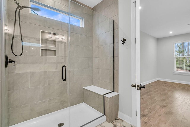 bathroom with wood-type flooring and a shower with door