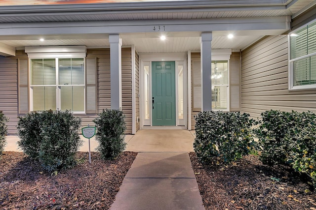 exterior entry at dusk featuring a porch