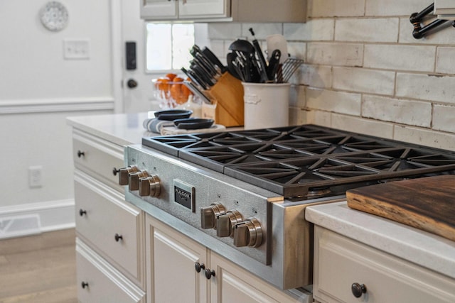 630 Cain Dr, Mount Pleasant, SC 29464 - kitchen view of decorative backsplash, stainless steel gas stovetop, and light countertops