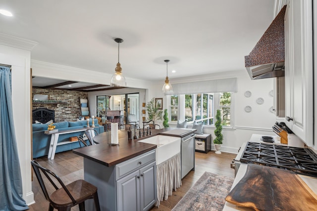 630 Cain Dr, Mount Pleasant, SC 29464 - kitchen featuring butcher block countertops, open floor plan, a sink, extractor fan, and light wood-type flooring