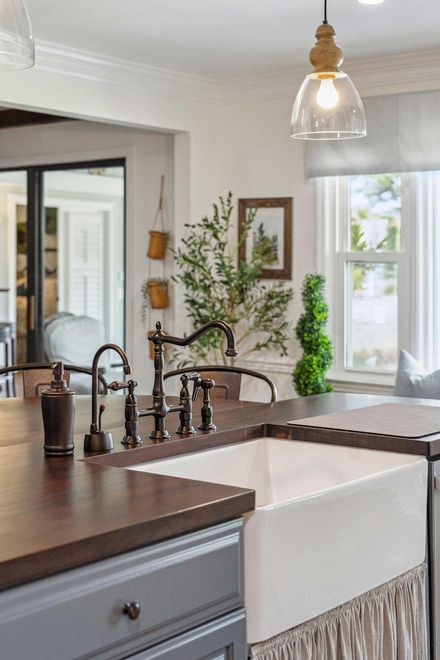 630 Cain Dr, Mount Pleasant, SC 29464 - kitchen with dark countertops, gray cabinetry, healthy amount of natural light, and ornamental molding