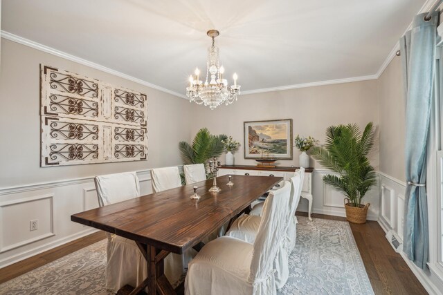 630 Cain Dr, Mount Pleasant, SC 29464 - dining space with a chandelier, ornamental molding, wood finished floors, a wainscoted wall, and a decorative wall