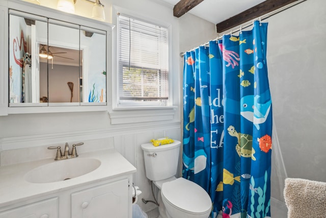 630 Cain Dr, Mount Pleasant, SC 29464 - bathroom featuring toilet, vanity, ceiling fan, a shower with shower curtain, and a wainscoted wall