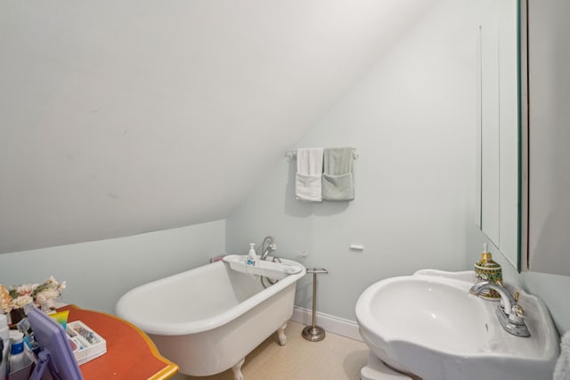 630 Cain Dr, Mount Pleasant, SC 29464 - full bathroom with a freestanding bath, lofted ceiling, a sink, and baseboards