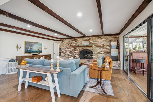 630 Cain Dr, Mount Pleasant, SC 29464 - living room with beam ceiling, hardwood / wood-style floors, brick wall, a brick fireplace, and wainscoting