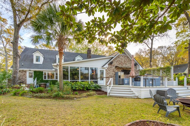 630 Cain Dr, Mount Pleasant, SC 29464 - back of house featuring brick siding, a lawn, a sunroom, and a chimney