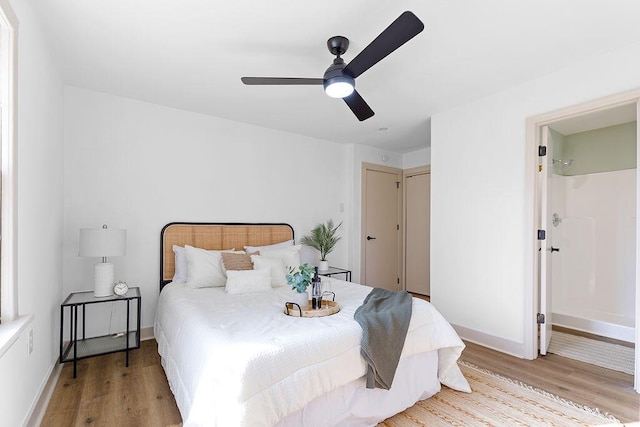 bedroom featuring light wood-style flooring, baseboards, and ceiling fan