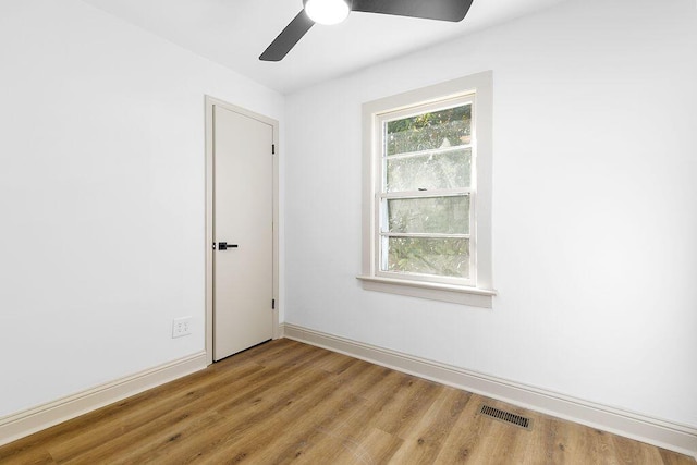 unfurnished room featuring a wealth of natural light, light wood-style flooring, and visible vents