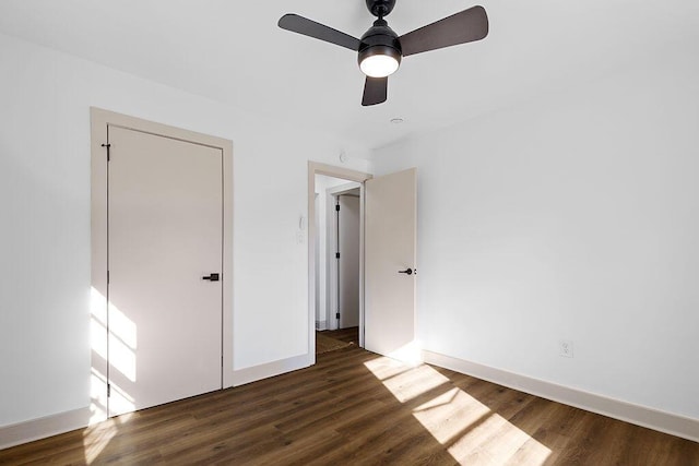 unfurnished bedroom with a ceiling fan, baseboards, and wood finished floors