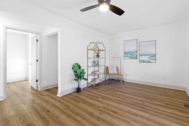 unfurnished room with visible vents, a ceiling fan, light wood-style flooring, and baseboards