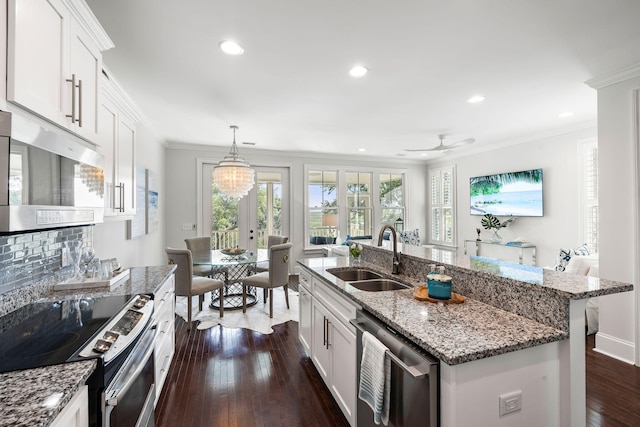 2087 Sterling Marsh Ln, Seabrook Island, SC 29455 - kitchen with stainless steel appliances, a sink, dark wood-type flooring, ornamental molding, and a ceiling fan