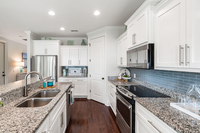 2087 Sterling Marsh Ln, Seabrook Island, SC 29455 - kitchen with stainless steel appliances, a sink, white cabinetry, crown molding, and dark wood-style floors