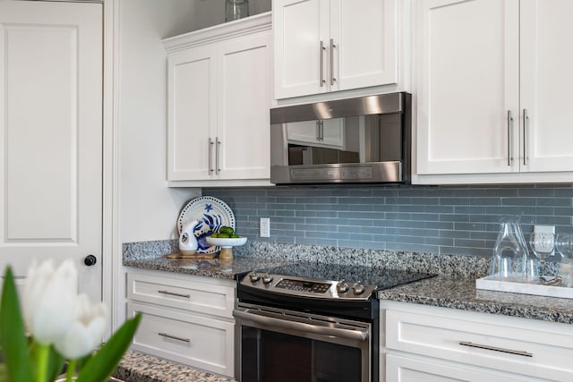 2087 Sterling Marsh Ln, Seabrook Island, SC 29455 - kitchen with stainless steel appliances, backsplash, white cabinetry, and dark stone countertops
