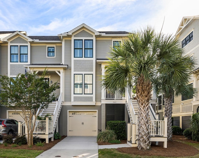 2087 Sterling Marsh Ln, Seabrook Island, SC 29455 - view of front facade with stairs, an attached garage, and driveway