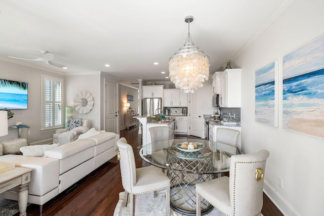 2087 Sterling Marsh Ln, Seabrook Island, SC 29455 - dining room with a chandelier, ornamental molding, dark wood-style flooring, recessed lighting, and baseboards