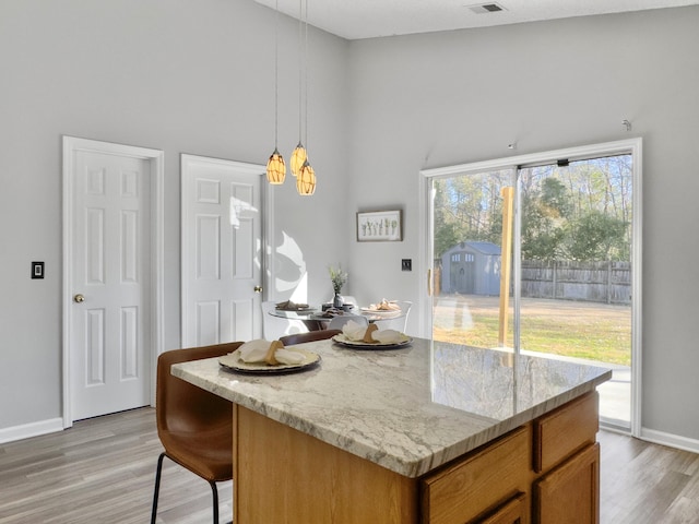 kitchen with a kitchen island, light hardwood / wood-style floors, and plenty of natural light