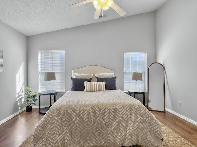 bedroom featuring a textured ceiling, ceiling fan, lofted ceiling, and dark hardwood / wood-style floors