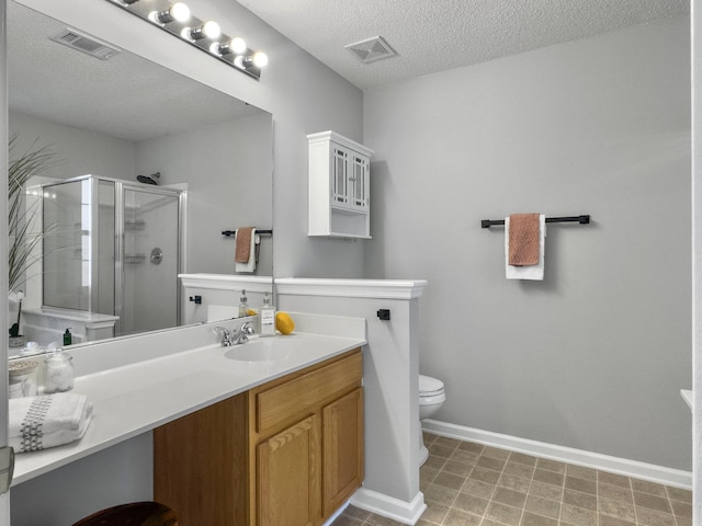 bathroom with a textured ceiling, toilet, an enclosed shower, and vanity