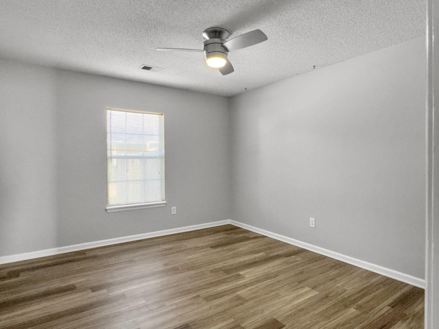 unfurnished room featuring ceiling fan, hardwood / wood-style floors, and a textured ceiling