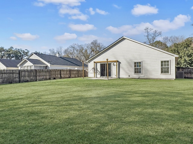 rear view of house with a lawn