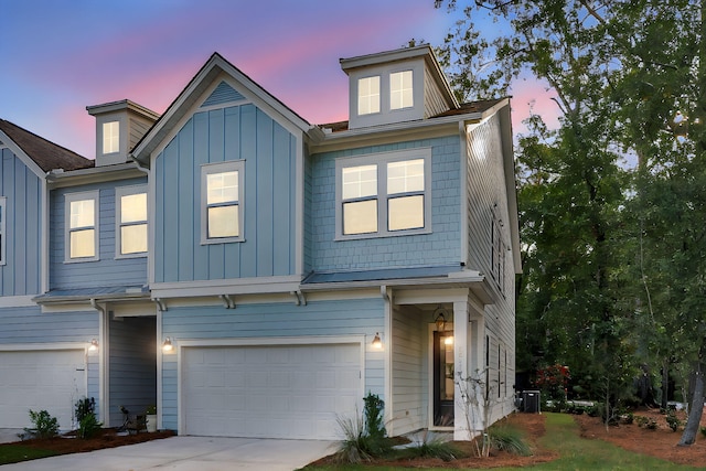 view of front of home featuring a garage and central air condition unit