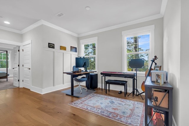 office with a wealth of natural light, hardwood / wood-style floors, and ornamental molding