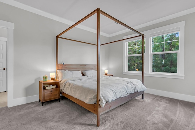 carpeted bedroom with ornamental molding