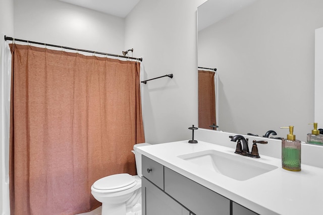 bathroom featuring a shower with curtain, vanity, and toilet