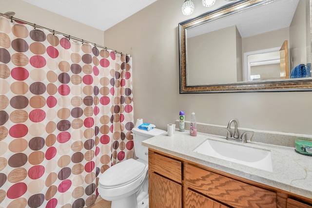 bathroom featuring tile patterned floors, vanity, and toilet