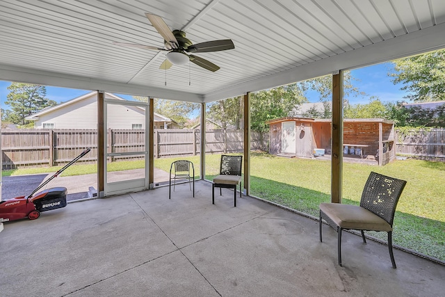 unfurnished sunroom featuring ceiling fan