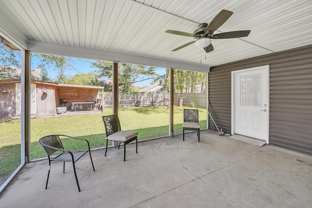 unfurnished sunroom featuring ceiling fan