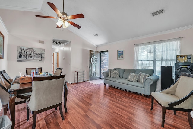 dining room with crown molding, ceiling fan, wood-type flooring, and vaulted ceiling