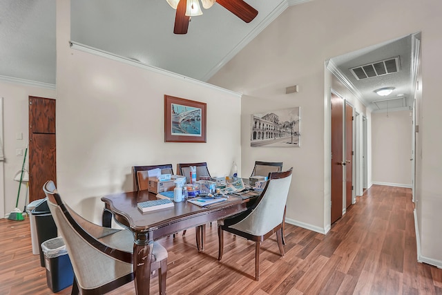 dining area featuring a textured ceiling, ceiling fan, wood-type flooring, and ornamental molding