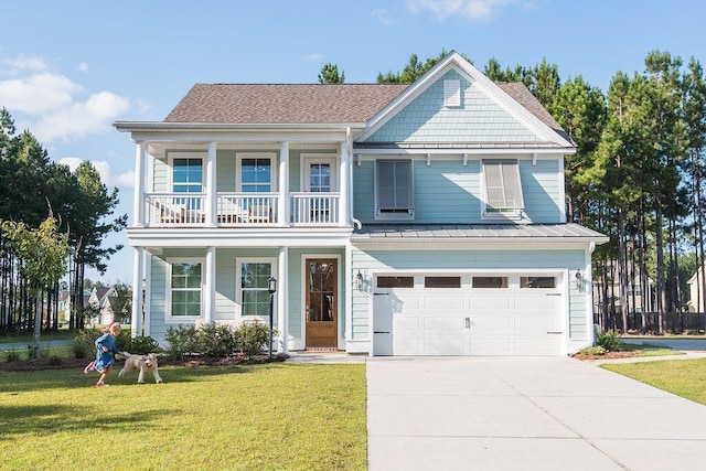 view of front of home with a garage, a front lawn, and a balcony