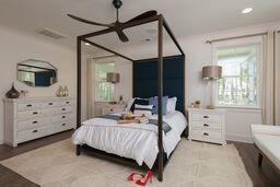 bedroom featuring multiple windows and ceiling fan