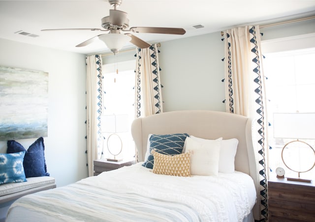 bedroom with ceiling fan and multiple windows