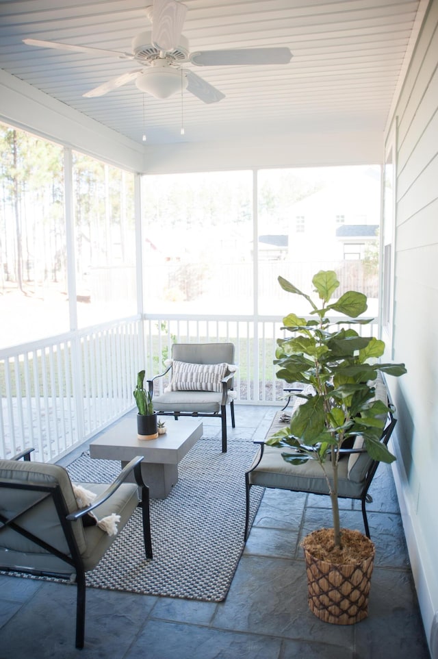 sunroom featuring ceiling fan