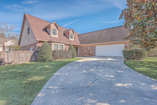 view of front of property featuring a garage and a front lawn