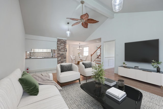 living room with ceiling fan with notable chandelier, hardwood / wood-style floors, high vaulted ceiling, and beam ceiling