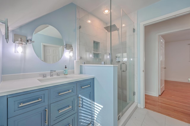 bathroom featuring tile patterned floors, walk in shower, and vanity