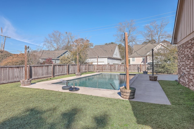 view of pool featuring a patio area and a yard